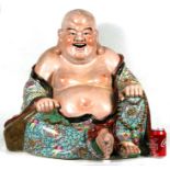 A large Chinese famille rose figure of a laughing seated Buddha, impressed four-character mark to