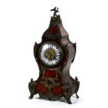 A 19th century French tortoiseshell and ormolu mounted mantle clock, the brass dial with enamel