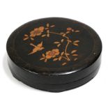 A Japanese lacquer lidded box decorated with flowers and a bird on a black ground, 33cms (13ins)