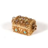 A Georgian un-hallmarked gold turquoise set charm in the form of a treasure chest with faceted stone