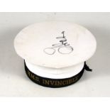 A Royal Navy cap with HMS Invincible tally.
