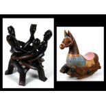 An African carved hardwood figural group, 38cms (15ins) high; together with a painted wooden rocking