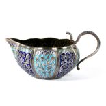 An Indian Kashmiri white metal and enamel jug with serpent handle, 14cms (5.5ins) wide.
