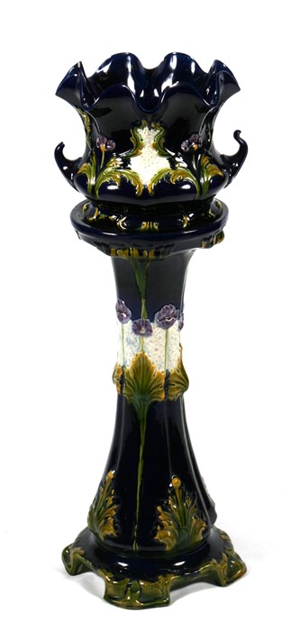 An Art Nouveau majolica jardiniere on stand, 87cms (34ins) high.Condition Report Tip of one handle
