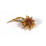 An Italian 18ct gold flower brooch set with rubies, stamped 18k, 6cms (2ins) high, 14.6g.