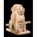 An early 20th century Inuit or Eskimo marine ivory Billiken good luck group, 8.5cms (3.25ins) high.