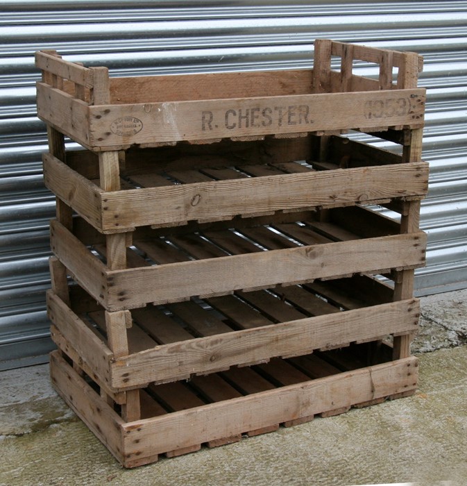 A group of five wooden apple crates.