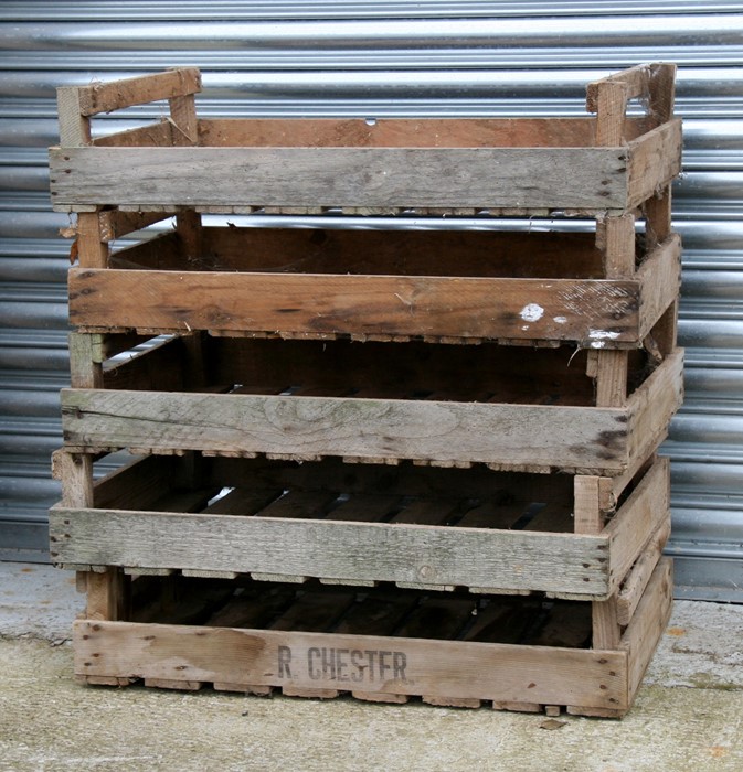 A group of five wooden apple crates.