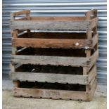 A group of five wooden apple crates.