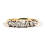 An 18ct gold seven stone diamond ring, stamped 18k, approx UK size 'S'.