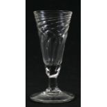 A 19th century wrythen moulded ale glass with snapped off pontil mark, 14cms (5.5in) high.