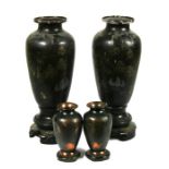 A pair of Chinese Foochow lacquer vases decorated with figures in a landscape, 31cms (12.25ins) high