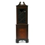 An Edwardian inlaid mahogany corner cupboard, the astragal glazed upper section enclosing a