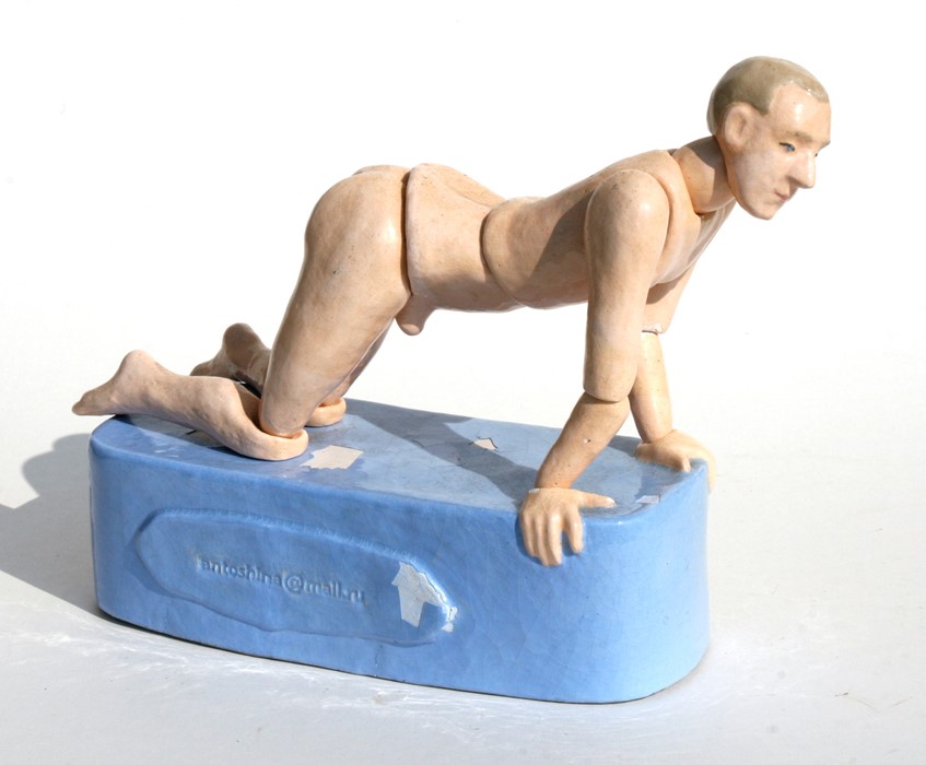 Tatiana Antoshina (Russian b1956) a glazed articulated pottery figure of a naked man kneeling on a