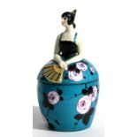 A French powder pot & cover in the form of a senorita, 19cms (7.5ins) high.