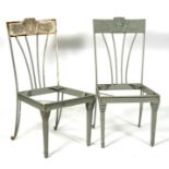 A pair of French style cast iron garden chairs.