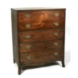 A Regency mahogany secretaire chest with false drawers dropping down to reveal an arrangement of