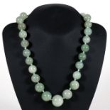 A Chinese graduated jade bead necklace, the largest bead 2cms diameter.