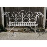 A white painted wrought iron scroll end garden bench, 140cms (55ins) wide.