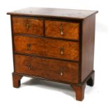 A Georgian style figured walnut chest of two short and two long graduated drawers, on bracket