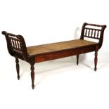 A Victorian mahogany bergere window seat with scroll ends, on turned legs, 147cms (58ins) wide.