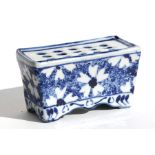 A blue & white spongeware flower brick, 12cms (4.75ins) wide.