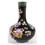 A Chinese cloisonne vase decorated with prunus on a black ground, 15cms (6ins) high.
