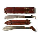 Two machetes in leather scabbards (2).