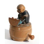 A Japanese Kobi toy depicting a seated figure eating a watermelon, 10cms (4ins) high.Condition