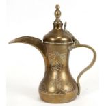 A Turkish / Islamic brass dallah coffee pot, 278cms (10.5ins) high.