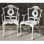 A pair of cast aluminium garden armed chairs.