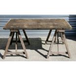 A plank top garden table on trestle supports, 140cms (55ins) wide.