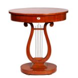 A French Empire style mahogany oval sewing table on lyre support, 69cms (27ins) wide.