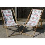 A pair of floral print garden deckchairs.