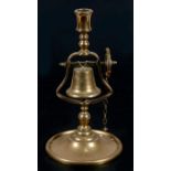 A 19th century brass tavern service candlestick, the bell rung by a wheel and chain, 29cms (11.5ins)