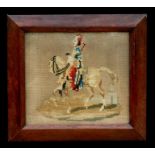 A 19th century framed needlework depicting a man riding a horse, 29 by 26cms (11.5 by 10.25ins).