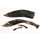 An Indian kukri in leather scabbard, 46cms (18ins) long.