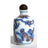 A Chinese snuff bottle decorated with animals within a landscape, six-character blue mark to