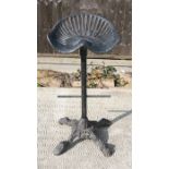 A cast iron tractor seat stool.