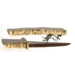 A late 19th / early 20th century Japanese bone tanto dagger, the handle and scabbard carved with