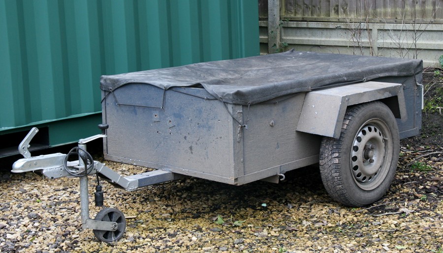 A 5ft by 3ft two-wheeled box trailer and covers.