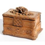 A Black Forest jewellery box surmounted with carved flowers, 19cms (7.5ins) wide.Condition Report