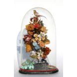A Victorian wax and plaster group depicting a bird, flowers and fruit, under a glass dome on an