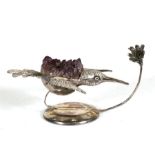 A Gerson Bahia white metal desk weight in the form of a hummingbird and flower, with amethyst geode,