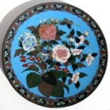 A Japanese Meiji period cloisonne charger decorated with birds, butterfly and flowers on a blue