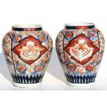 A pair of Japanese Imari vases, 21cms (8.25ins) high.