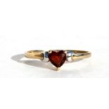 A 9ct gold dress ring set with a heart shaped garnet, approx UK size 'O'.