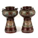 A pair of 19th century Japanese bronze and Champlevé enamel vases decorated with flowers and
