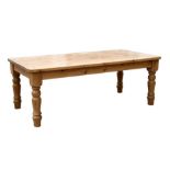 A large pine farmhouse kitchen table on substantial turned legs, 203 by 107cms (84 by 42ins).