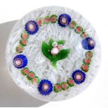 A 19th century French paperweight, possibly Clichy, decorated with central flowers and millefiori